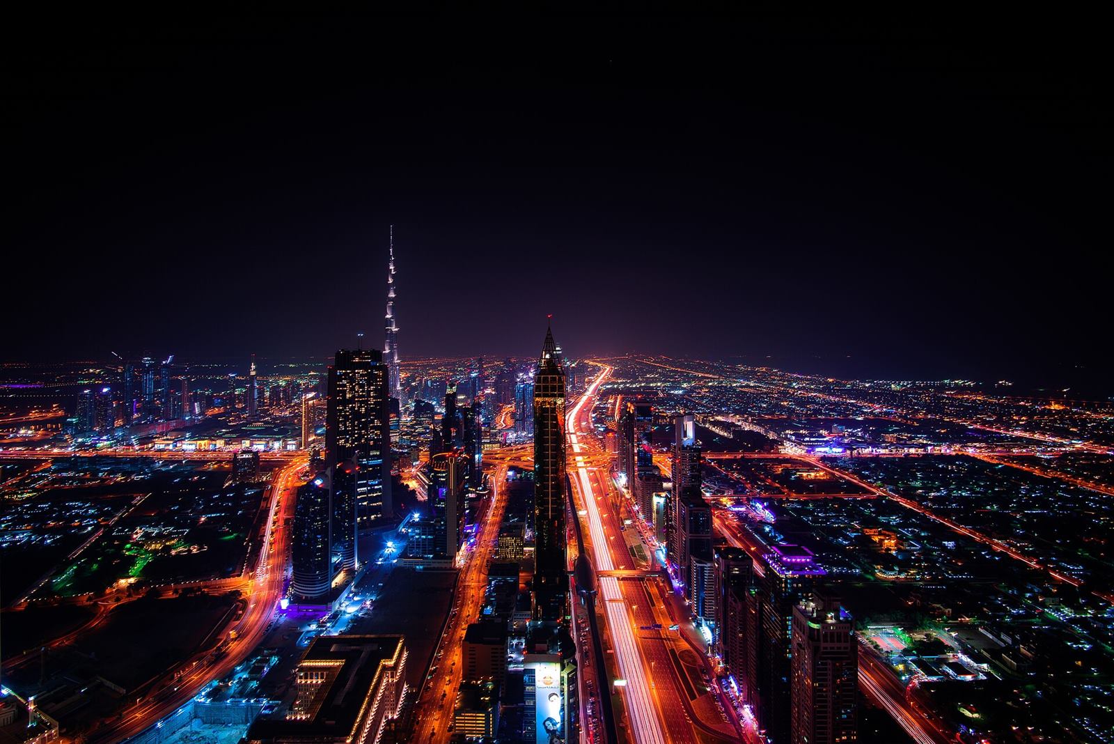 Downtown Dubai from above at night, with busy lit roads
